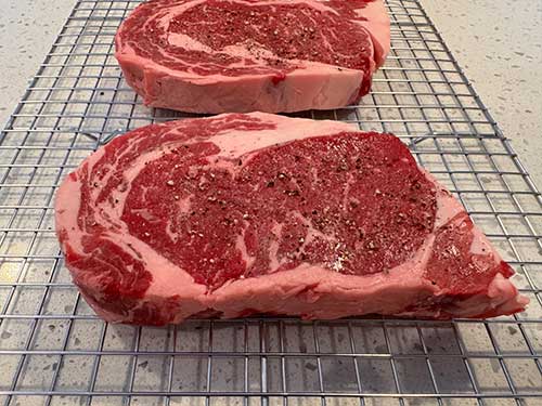 Season steak and pat dry