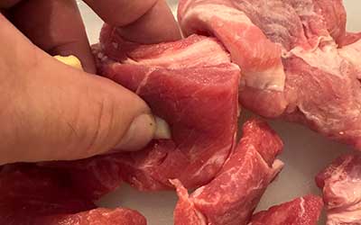 Cut pork shoulder into smaller chunks