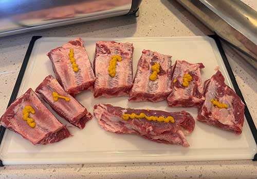 Dab mustard on ribs