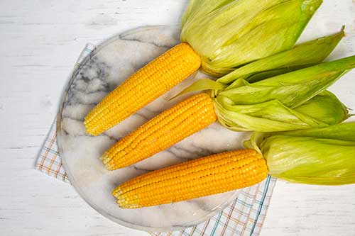 Open the husks and put back on the grill