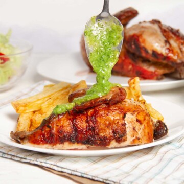 Peruvian Chicken with green sauce on a plate