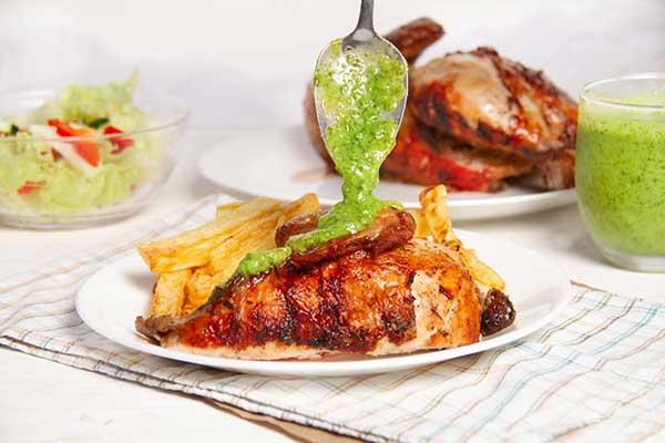 Peruvian chicken with green sauce served